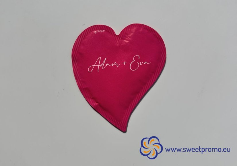 Pink heart-shaped promotional sugar with your own print. Originally packaged sugar for coffee and tea, suitable for hotels, restaurants, corporate events and catering, trade fairs and conferences.
