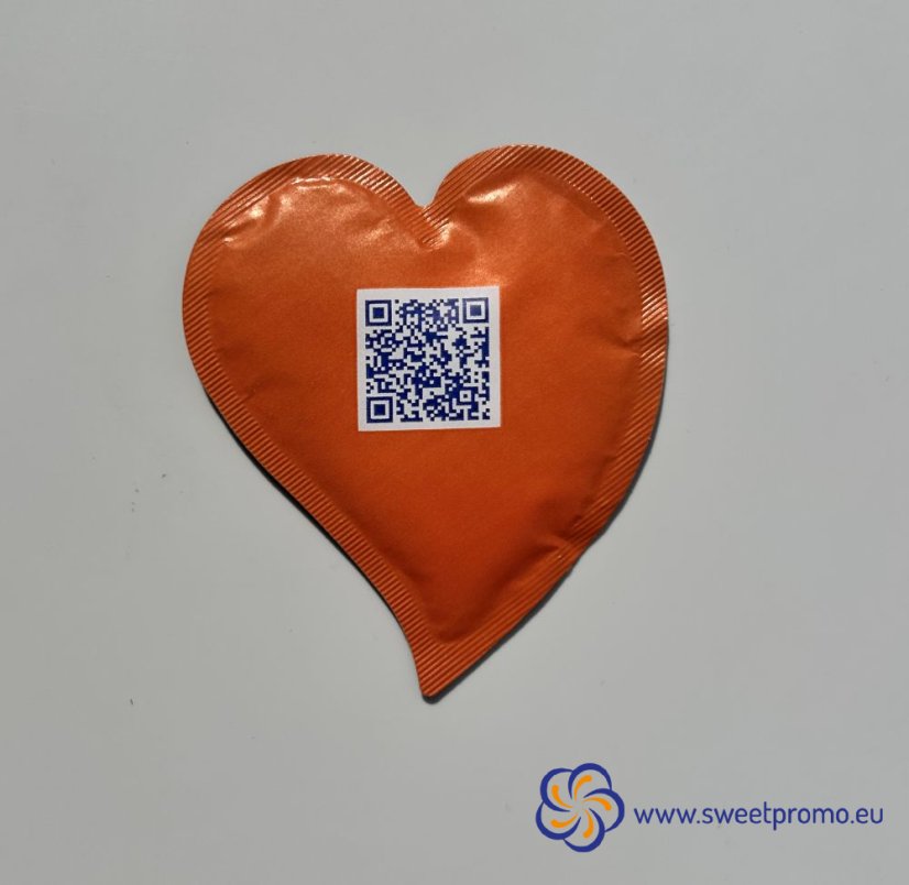Orange heart-shaped promotional sugar with your own print. Originally packaged sugar for coffee and tea, suitable for hotels, restaurants, corporate events and catering, trade fairs and conferences.
