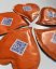 Orange heart-shaped promotional sugar with your own print. Originally packaged sugar for coffee and tea, suitable for hotels, restaurants, corporate events and catering, trade fairs and conferences.